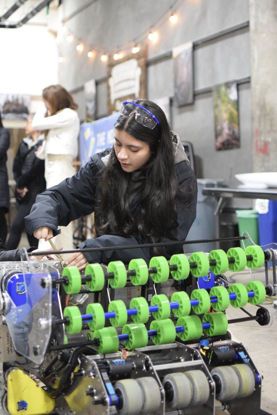 Afrah Nazar working on the Missfits robot at an event